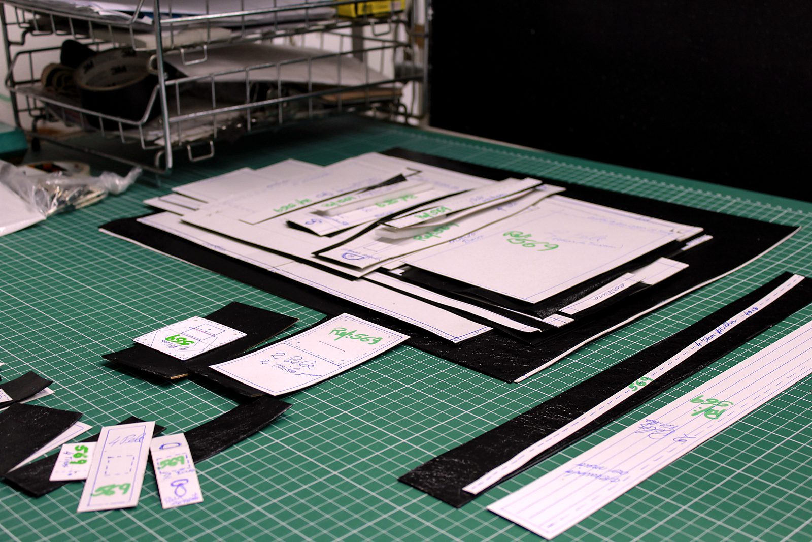 Patterns, labels and leather pieces prepared for a client's development