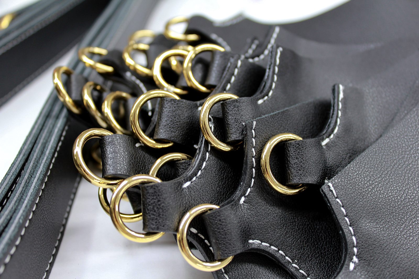 Black leather tabs fitted with gold rings