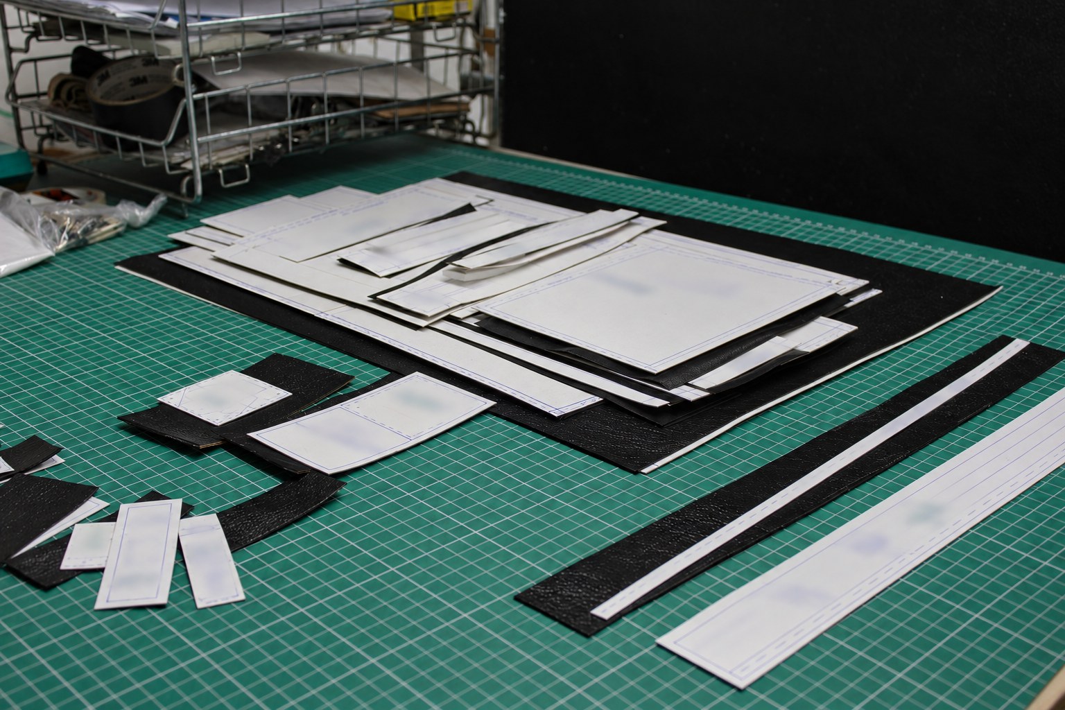 Cardboard patterns and cut leather pieces for a new development